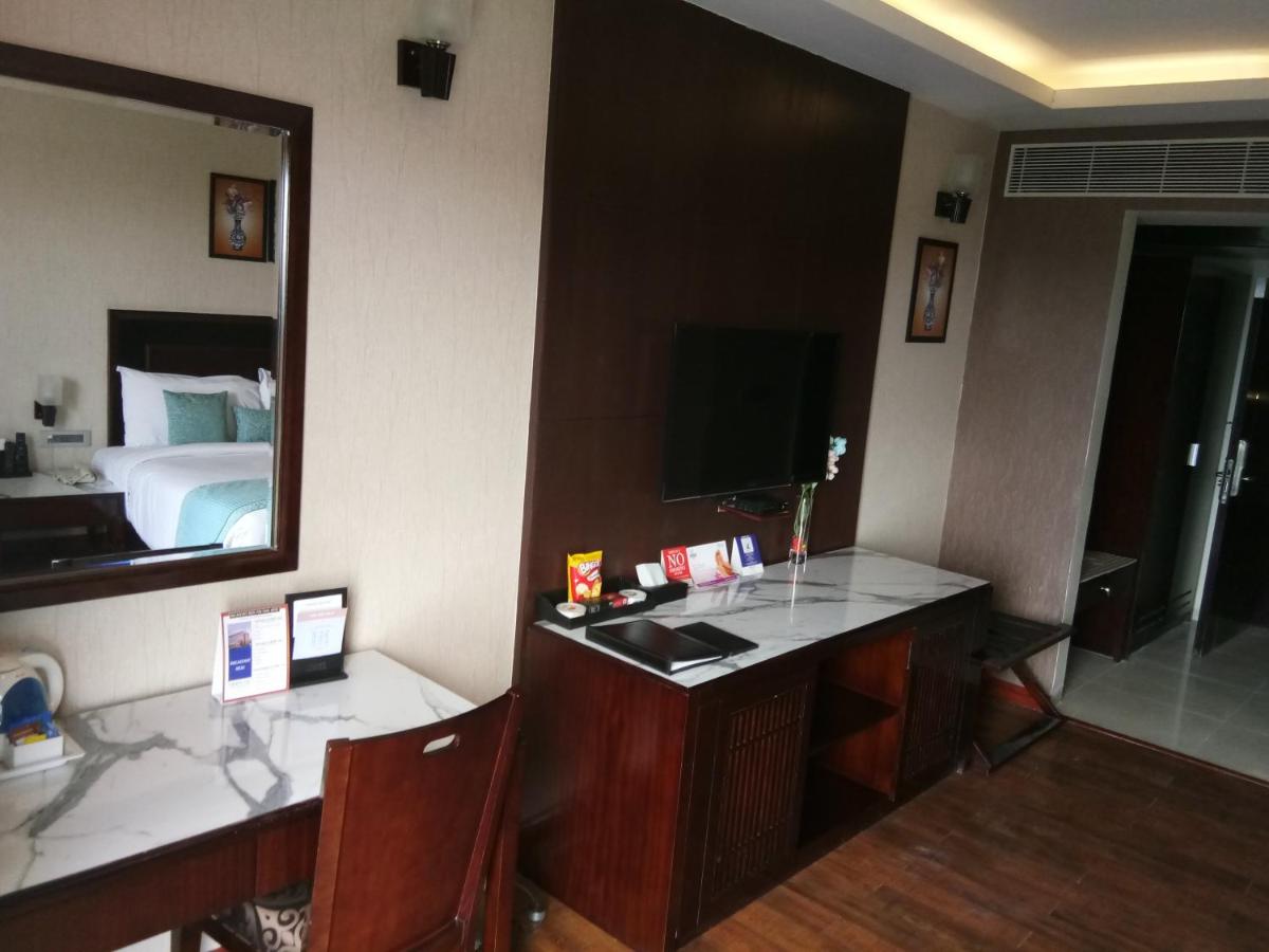 a hotel room with a desk and a mirror at Fortune Select Grand Ridge, Tirupati - Member ITC Hotels' Group in Tirupati