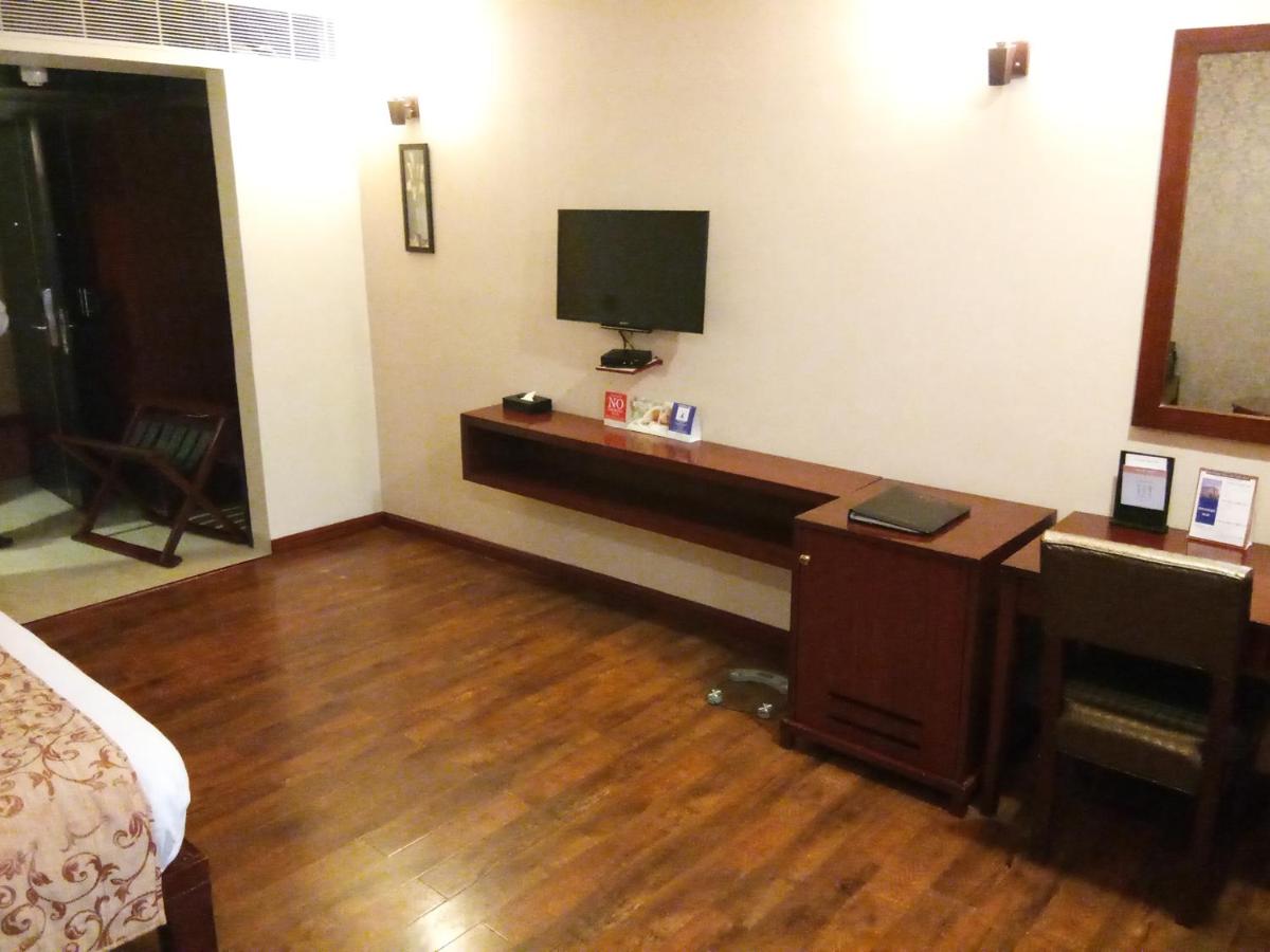 a hotel room with a desk with a tv on the wall at Fortune Select Grand Ridge, Tirupati - Member ITC Hotels' Group in Tirupati