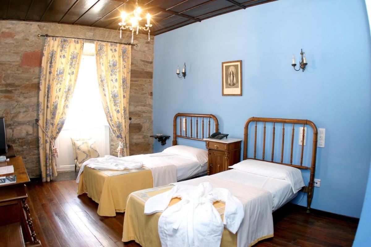 Cama o camas de una habitación en Hotel Monumento Pazo do Castro