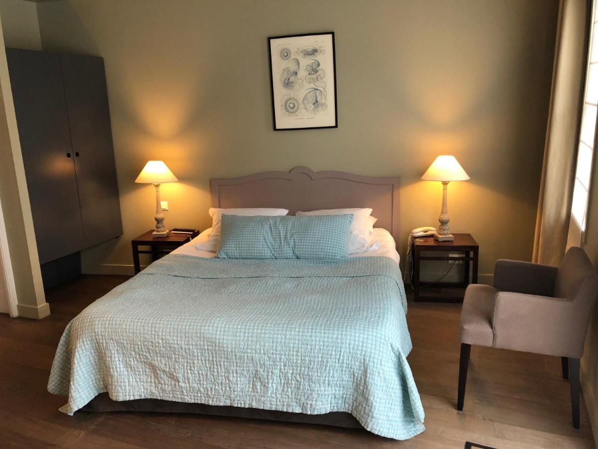 Un ou plusieurs lits dans un hébergement de l'établissement Hotel L'Océan