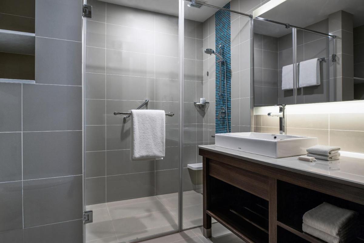a bathroom with a sink and a mirror at The Residency Towers, Rameswaram in Rāmeswaram