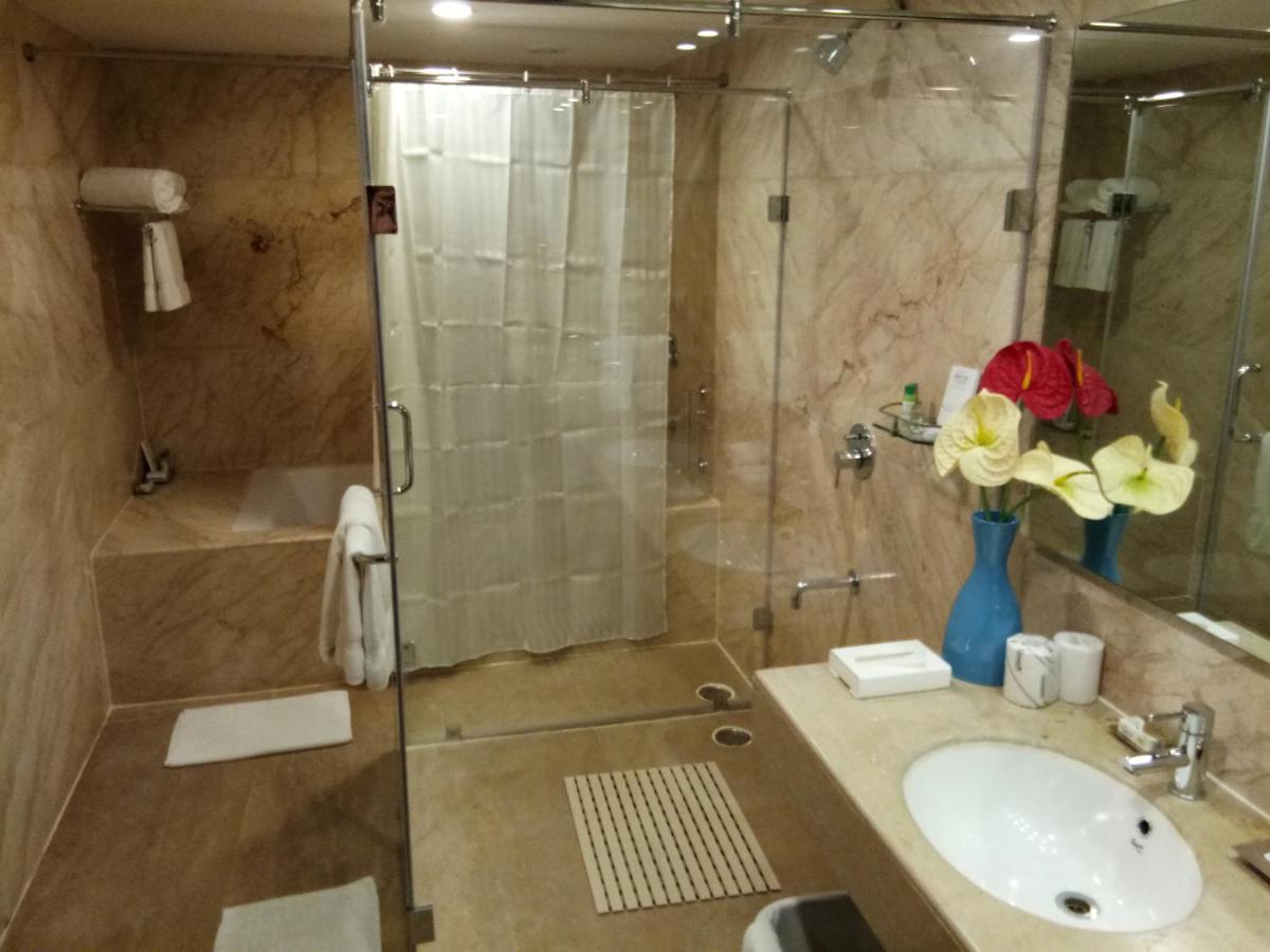 a bathroom with a sink and a glass shower at Fortune Select Grand Ridge, Tirupati - Member ITC Hotels' Group in Tirupati