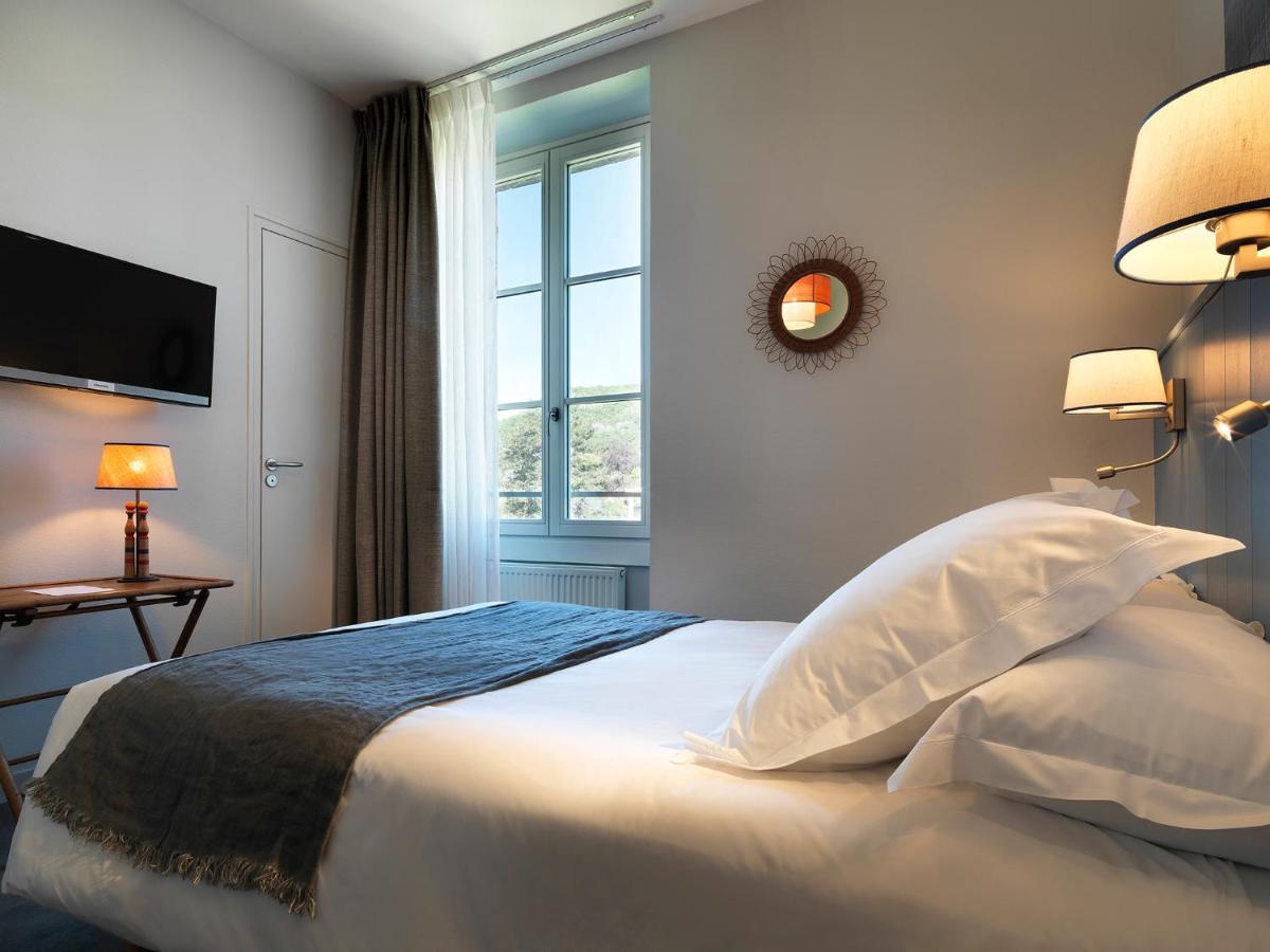 Un ou plusieurs lits dans un hébergement de l'établissement Hôtel Beau Site Talloires B SPA
