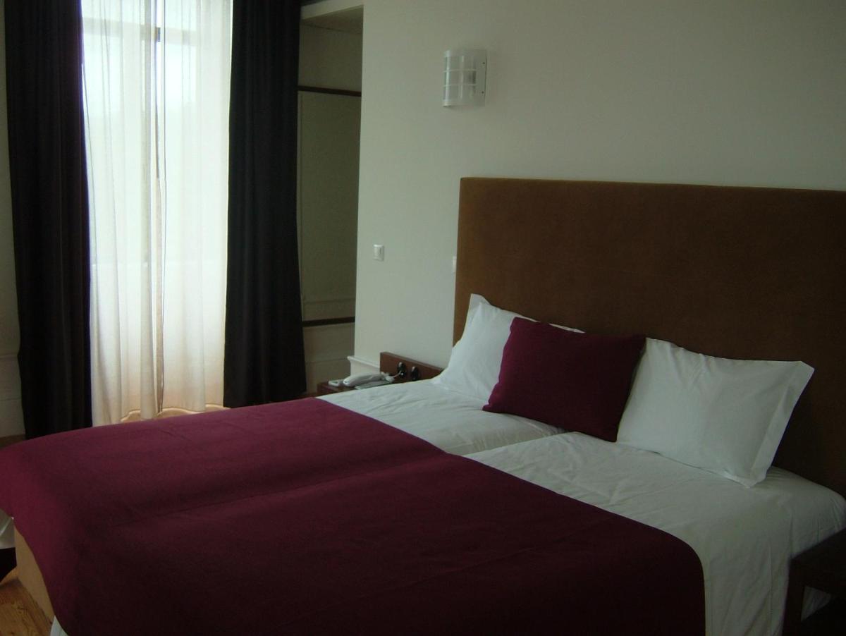 Uma cama ou camas num quarto em Hotel Quinta da Cruz & SPA