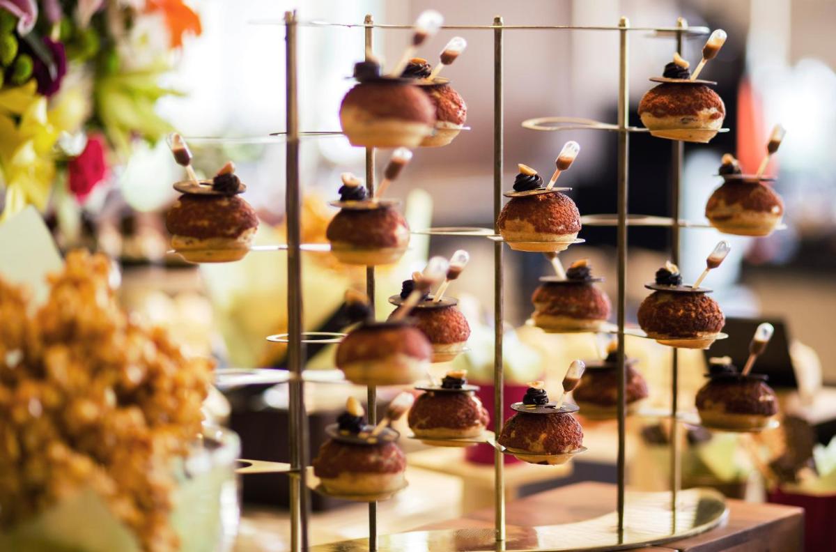 a display of cakes with hats on top of them at Taj Palace, New Delhi in New Delhi a display of cakes with hats on top of them at Taj Palace, New Delhi in New Delhi