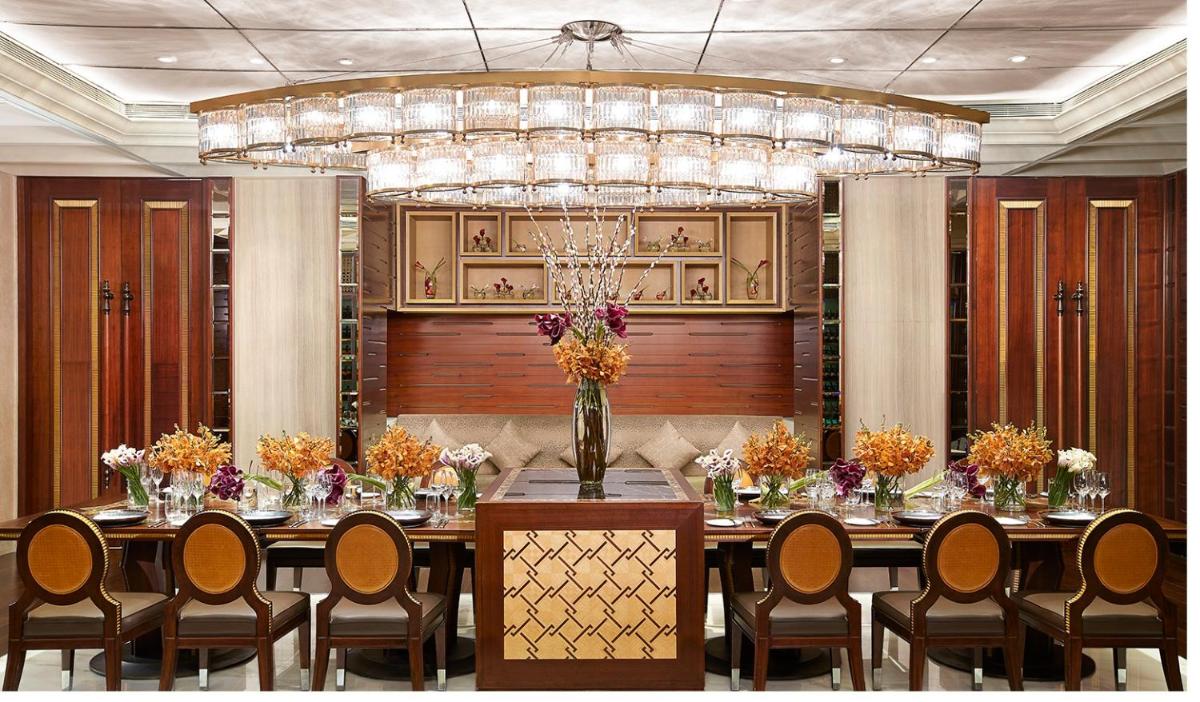 a large dining room with a long table and chairs at Four Seasons Hotel Mumbai in Mumbai