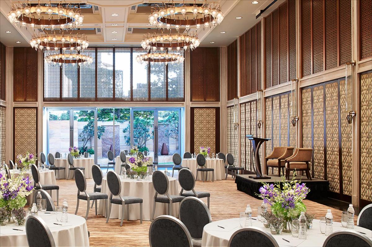 a banquet hall with tables and chairs and chandeliers at Four Seasons Hotel Mumbai in Mumbai