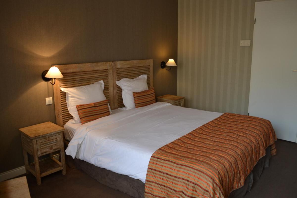 Un ou plusieurs lits dans un hébergement de l'établissement Almoria Hôtel & SPA