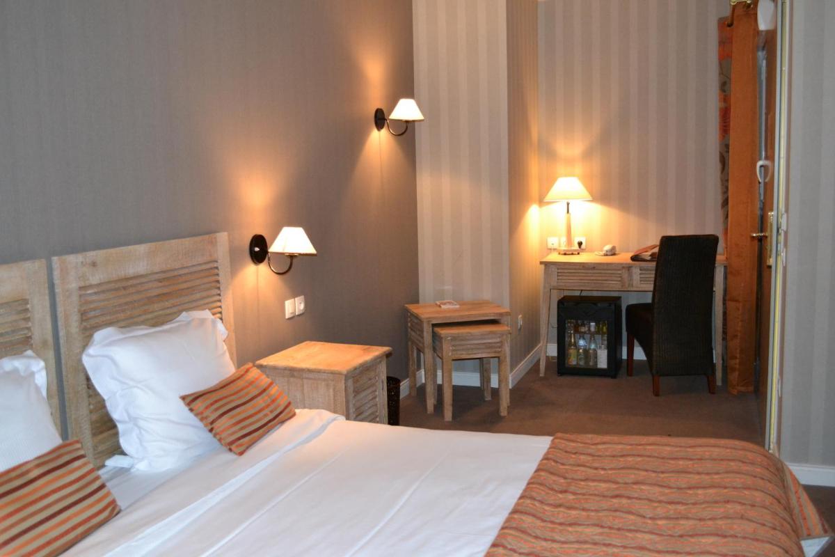 Un ou plusieurs lits dans un hébergement de l'établissement Almoria Hôtel & SPA