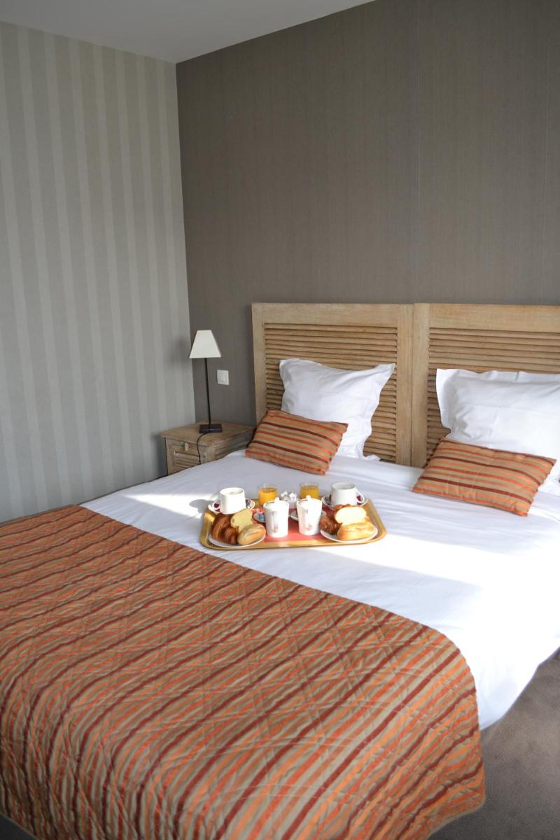 Un ou plusieurs lits dans un hébergement de l'établissement Almoria Hôtel & SPA