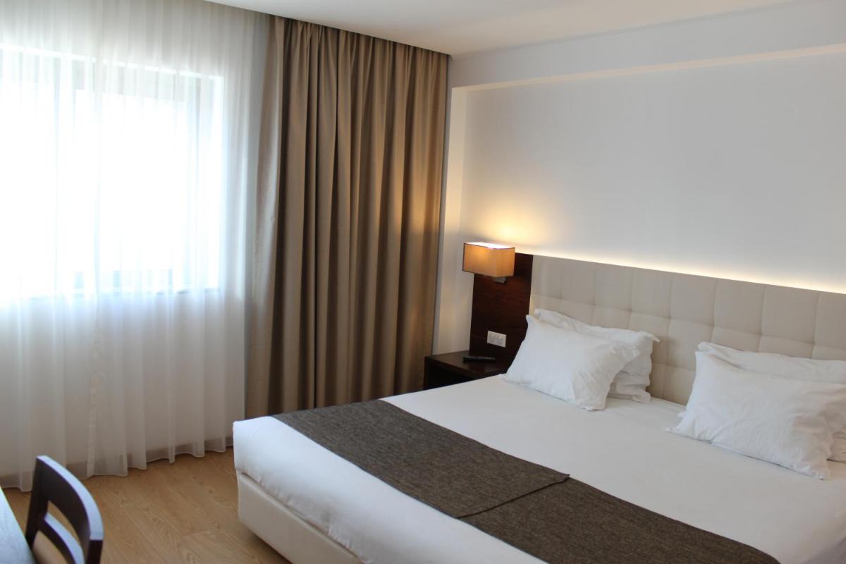 Uma cama ou camas num quarto em Hotel O Gato & Spa
