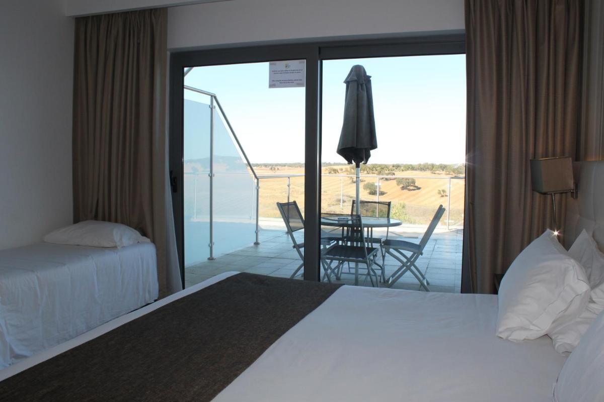 Uma cama ou camas num quarto em Hotel O Gato & Spa