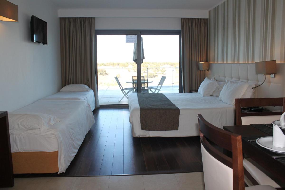 Uma cama ou camas num quarto em Hotel O Gato & Spa