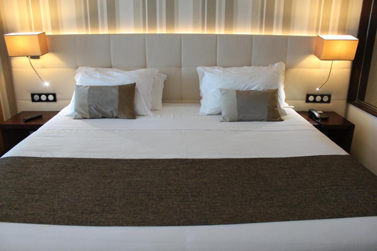 Uma cama ou camas num quarto em Hotel O Gato & Spa
