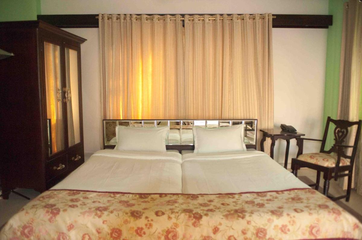 a bedroom with a large bed and a window at Royal Heritage Haveli - By Leisure Hotels in Jaipur
