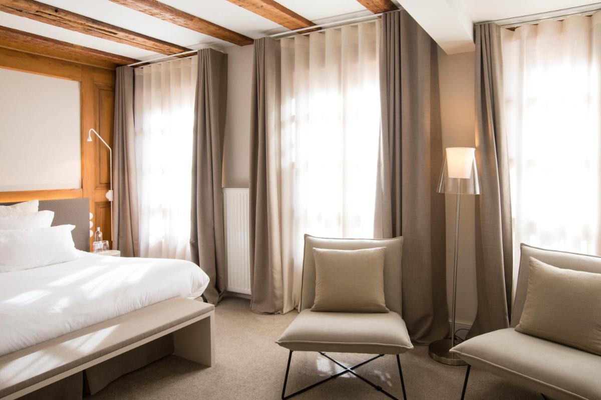 Un ou plusieurs lits dans un hébergement de l'établissement Relais & Châteaux La Maison Des Têtes