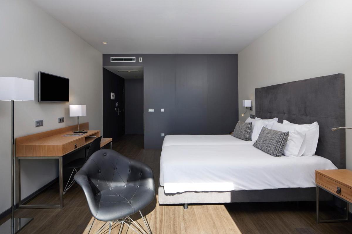 Uma cama ou camas num quarto em Alcazar Hotel & SPA