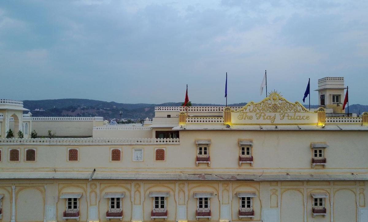 a building with a sign on the top of it at The Raj Palace (Small Luxury Hotels of the World) in Jaipur