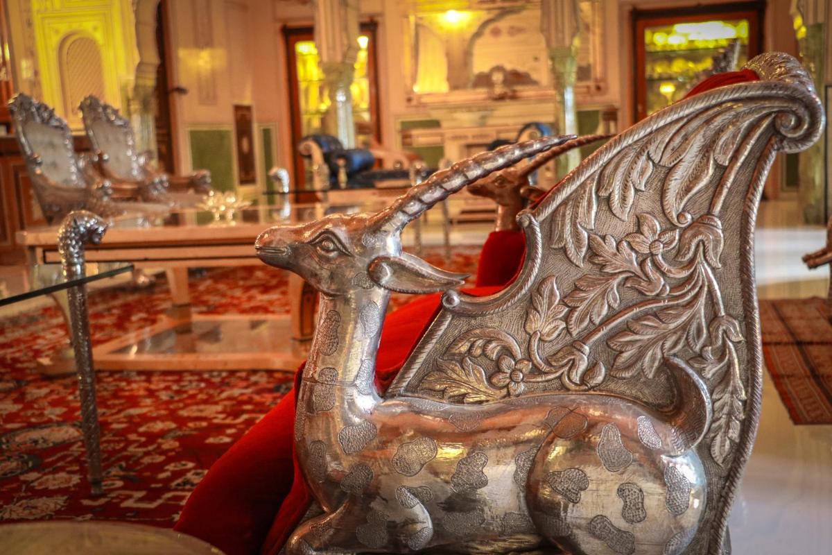 a metal chair with a dragon design on it at The Raj Palace (Small Luxury Hotels of the World) in Jaipur