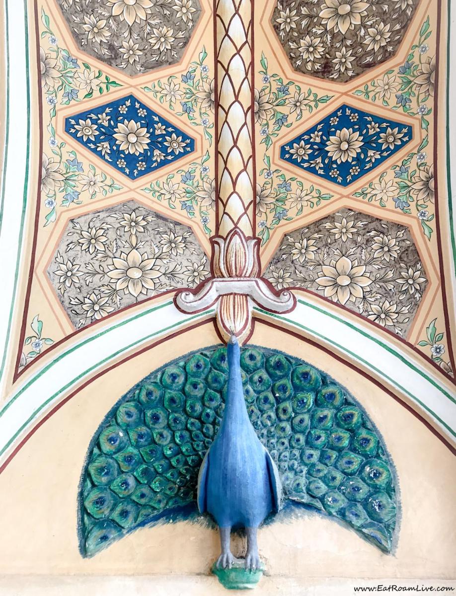 a painting of a blue peacock on a ceiling at The Raj Palace (Small Luxury Hotels of the World) in Jaipur