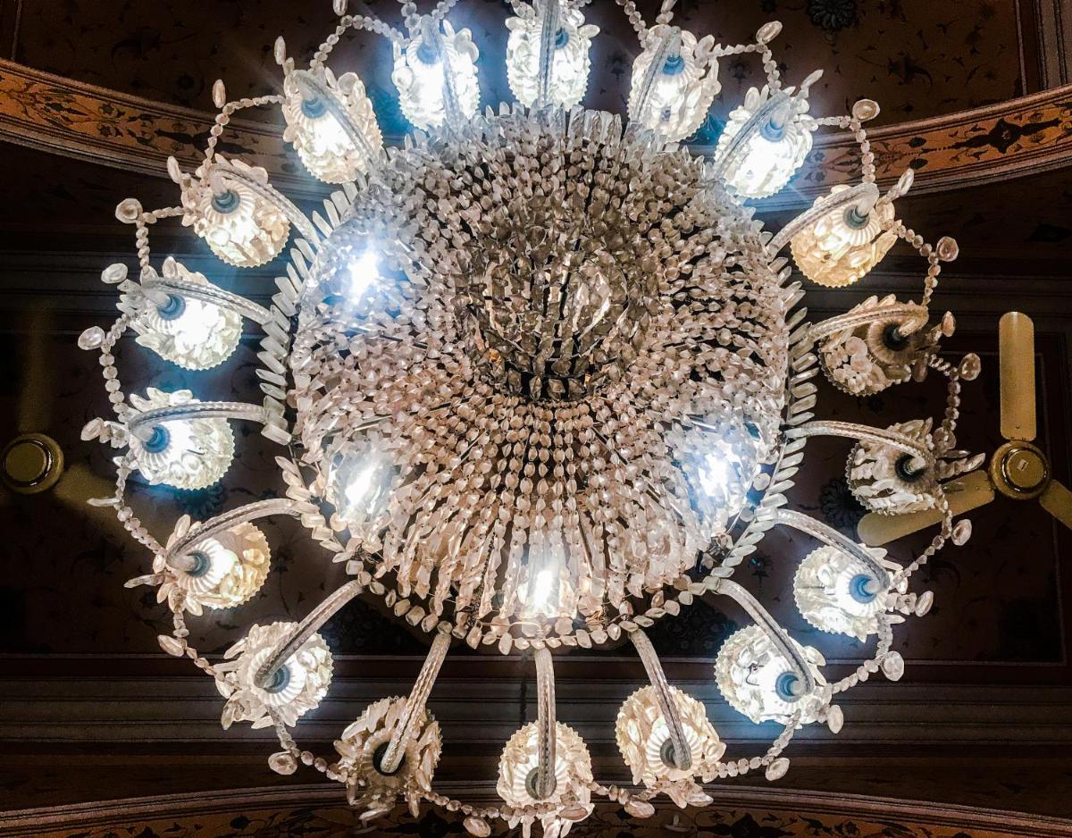 a large chandelier hanging from a ceiling at The Raj Palace (Small Luxury Hotels of the World) in Jaipur
