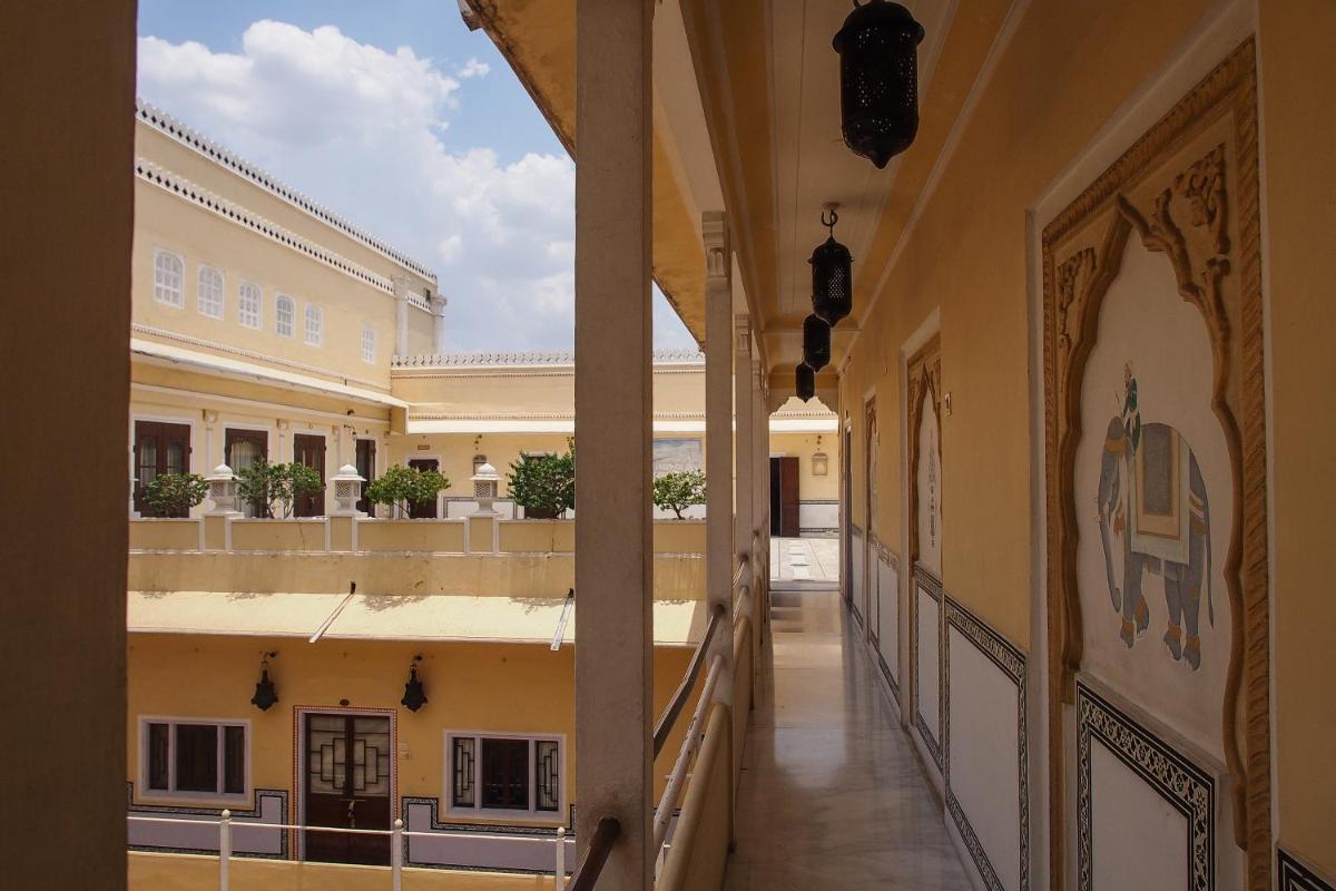 an empty hallway in a building with a view of a building at The Raj Palace (Small Luxury Hotels of the World) in Jaipur