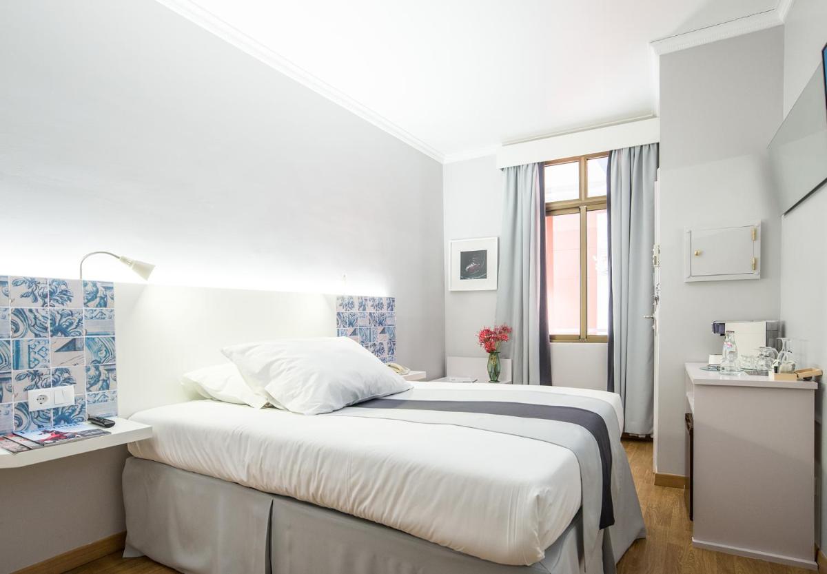 Uma cama ou camas num quarto em Sé Boutique Hotel