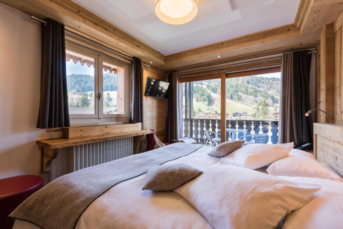 Un ou plusieurs lits dans un hébergement de l'établissement Hotel le Petit Dru