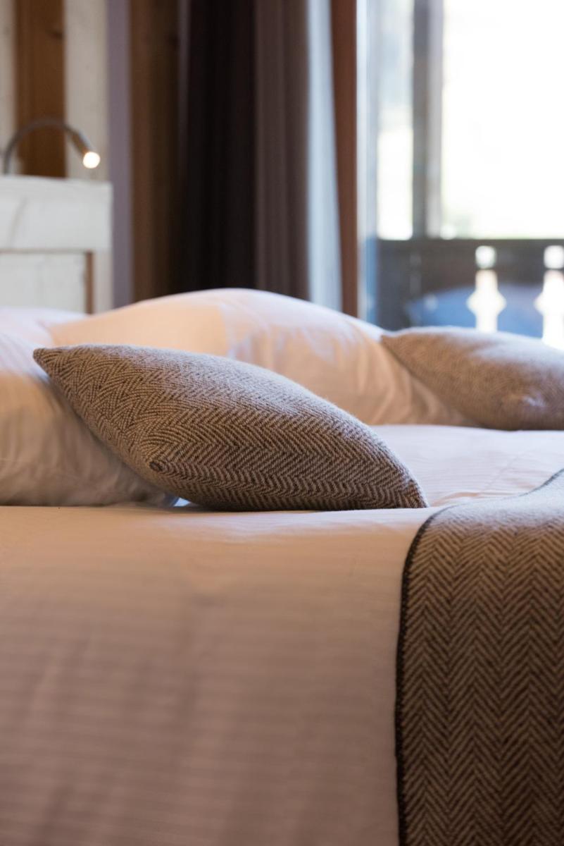 Un ou plusieurs lits dans un hébergement de l'établissement Hotel le Petit Dru