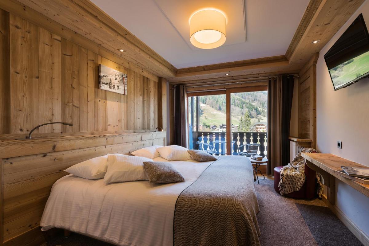 Un ou plusieurs lits dans un hébergement de l'établissement Hotel le Petit Dru