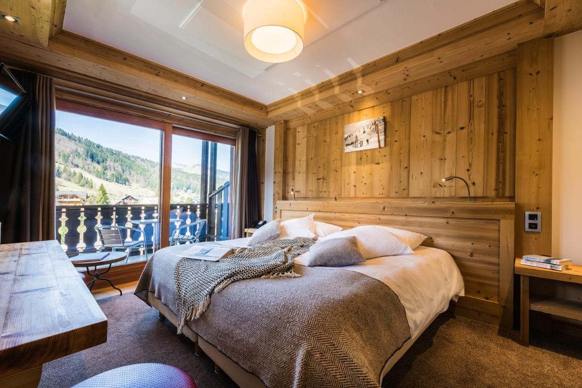 Un ou plusieurs lits dans un hébergement de l'établissement Hotel le Petit Dru