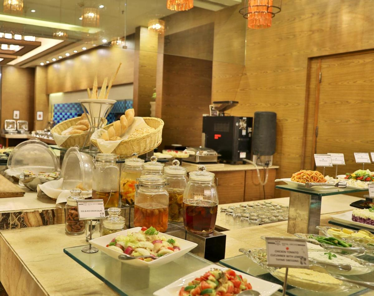 a buffet line with different types of food on display at Hotel Royal Orchid Jaipur, Tonk Road in Jaipur