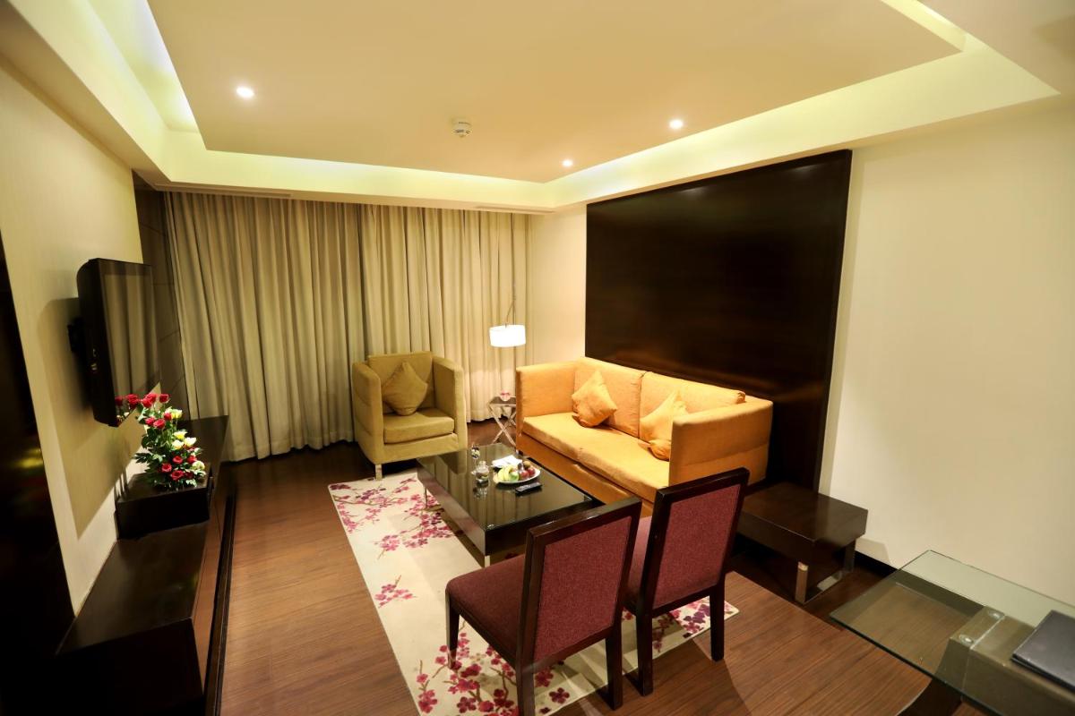 a living room with a couch and a table at Hotel Royal Orchid Jaipur, Tonk Road in Jaipur