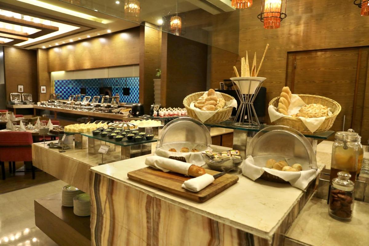 a kitchen with a bunch of food on a counter at Hotel Royal Orchid Jaipur, Tonk Road in Jaipur
