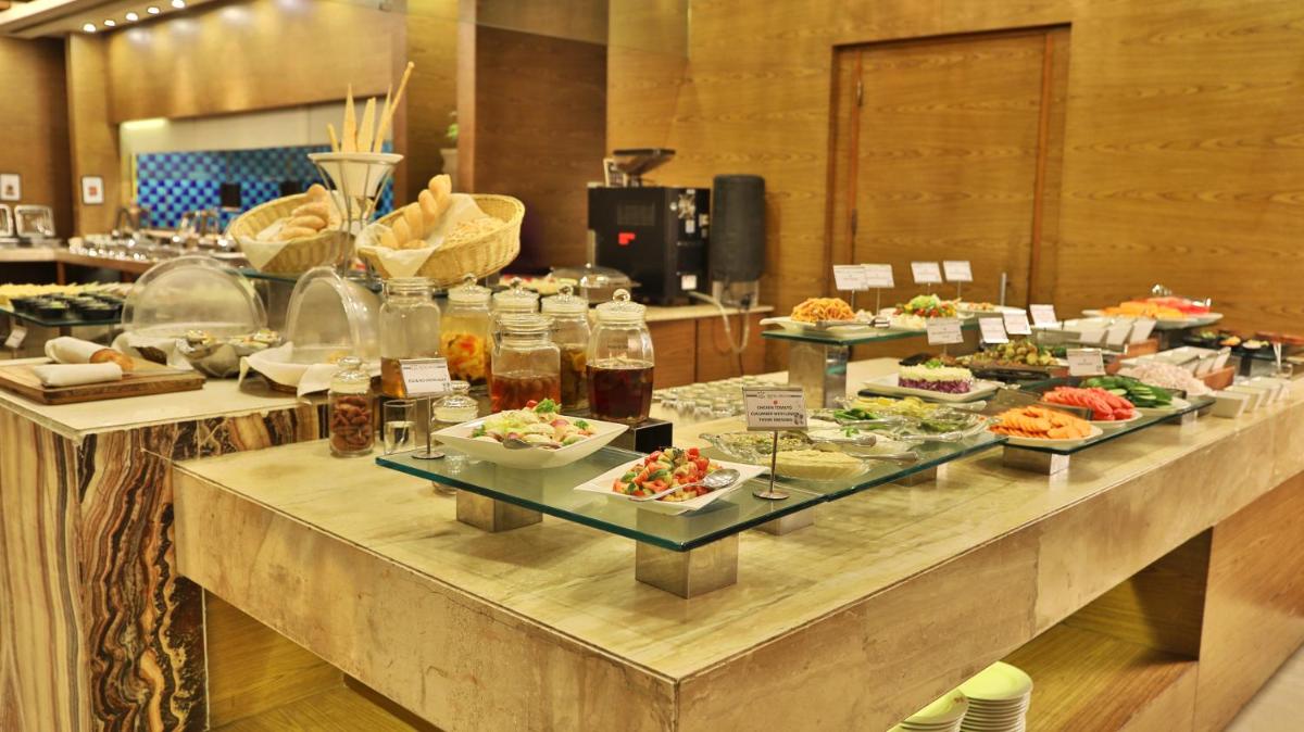a buffet line with many different types of food at Hotel Royal Orchid Jaipur, Tonk Road in Jaipur