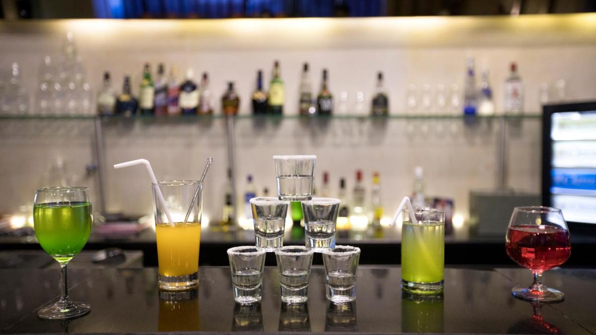 a group of wine glasses sitting on a bar at Hotel Royal Orchid Jaipur, Tonk Road in Jaipur