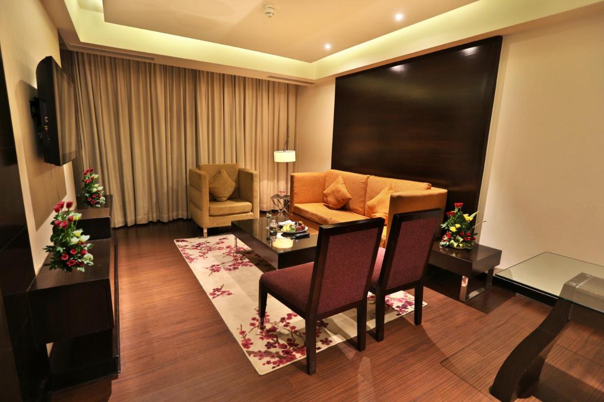 a living room with a couch and a table at Hotel Royal Orchid Jaipur, Tonk Road in Jaipur