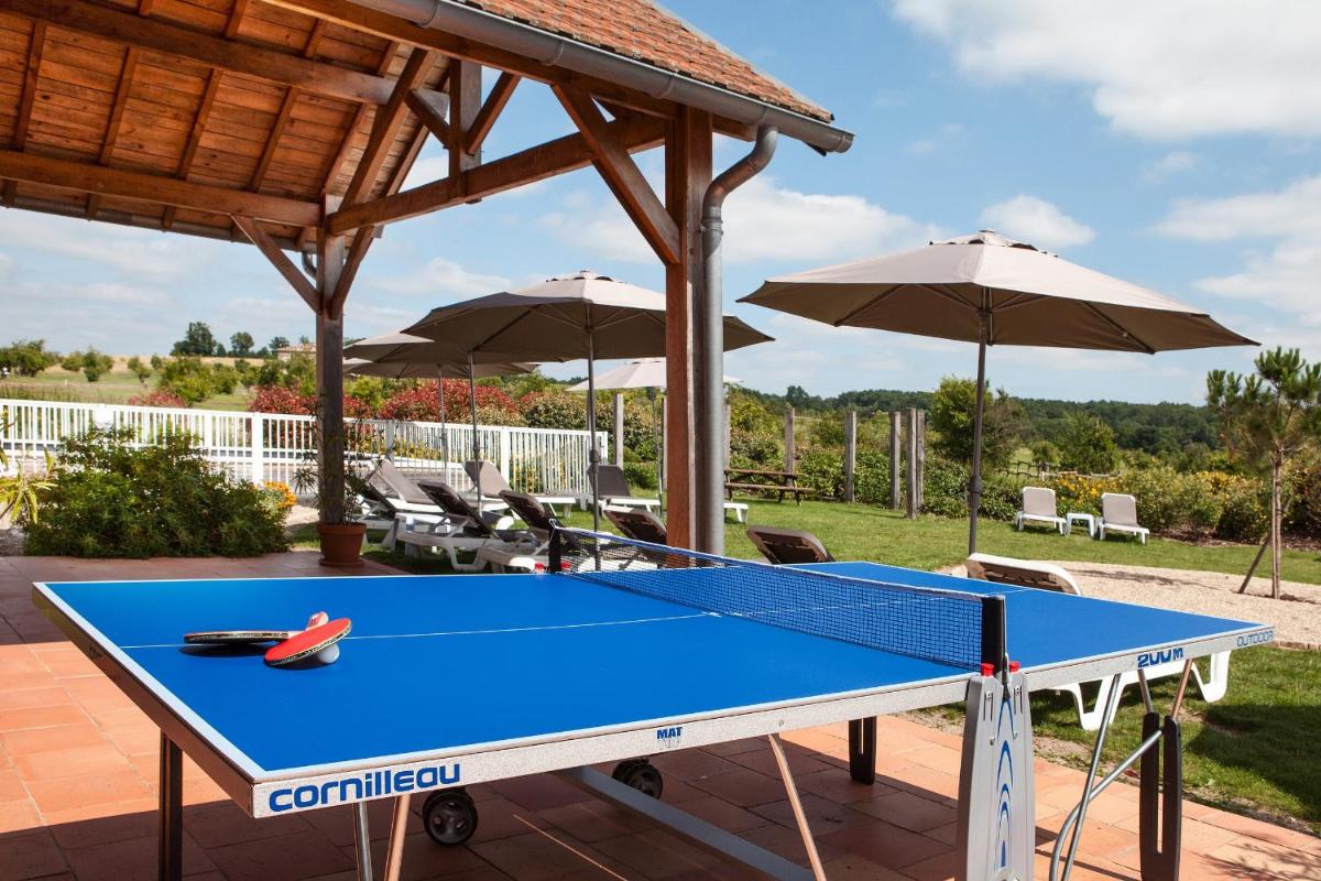 - une table de ping-pong sur une terrasse avec des parasols dans l'établissement Relais des Vigiers, à Monestier
