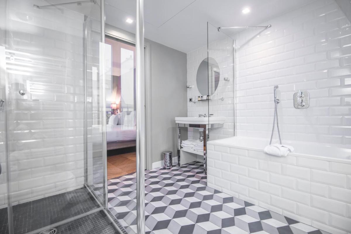 une salle de bain avec une douche, une baignoire et un lavabo dans l'établissement Monsieur Cadet Hotel & Spa, à Paris 118 autres photos