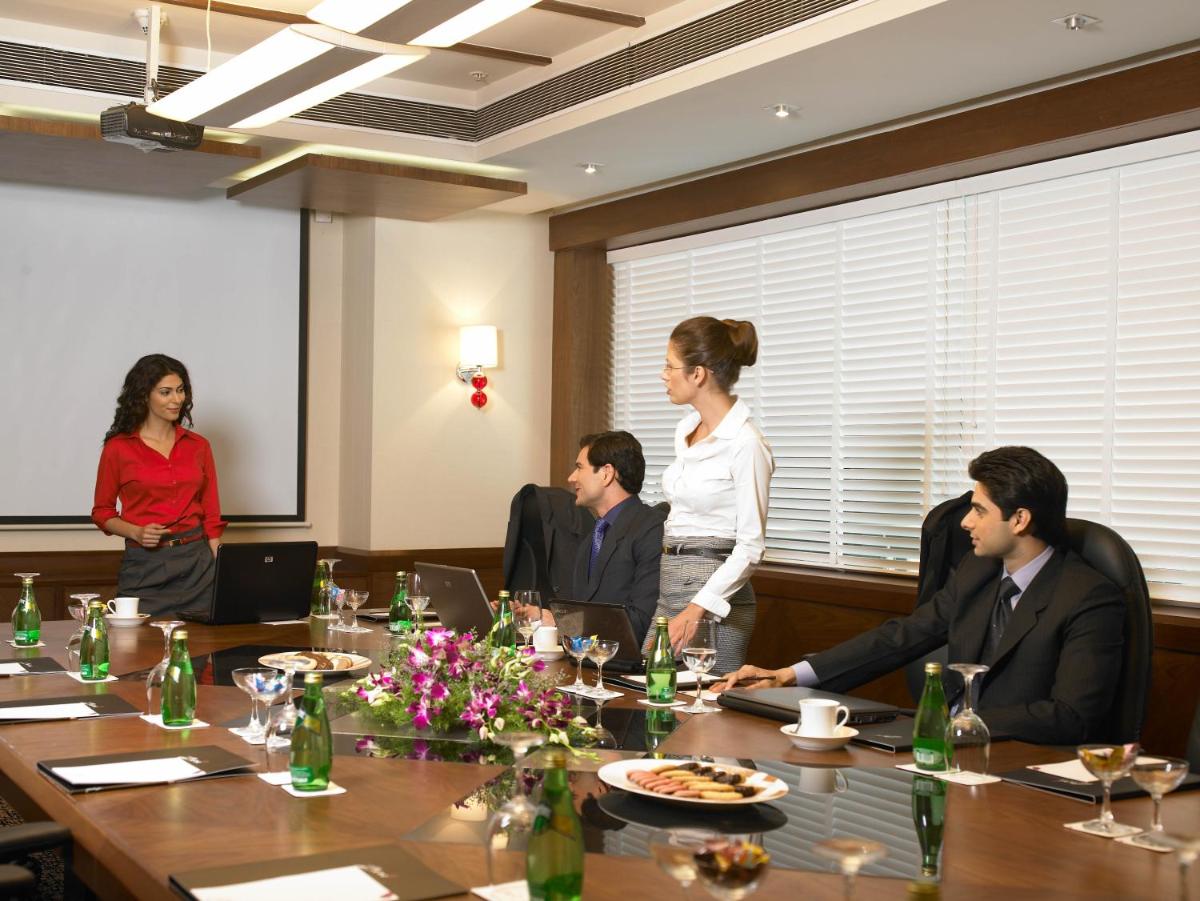 a group of people sitting around a table in a conference room at The Zuri Whitefield Bengaluru in Bengaluru