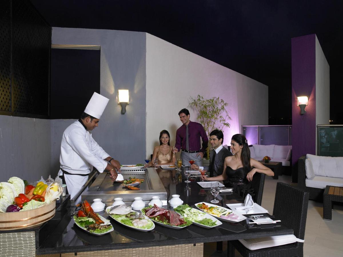 a chef preparing food in front of a group of people at The Zuri Whitefield Bengaluru in Bengaluru