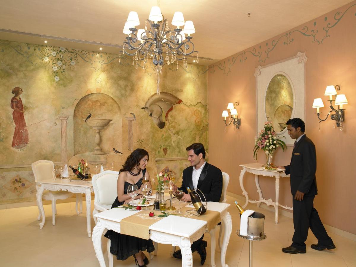 a group of people sitting at a table in a restaurant at The Zuri Whitefield Bengaluru in Bengaluru