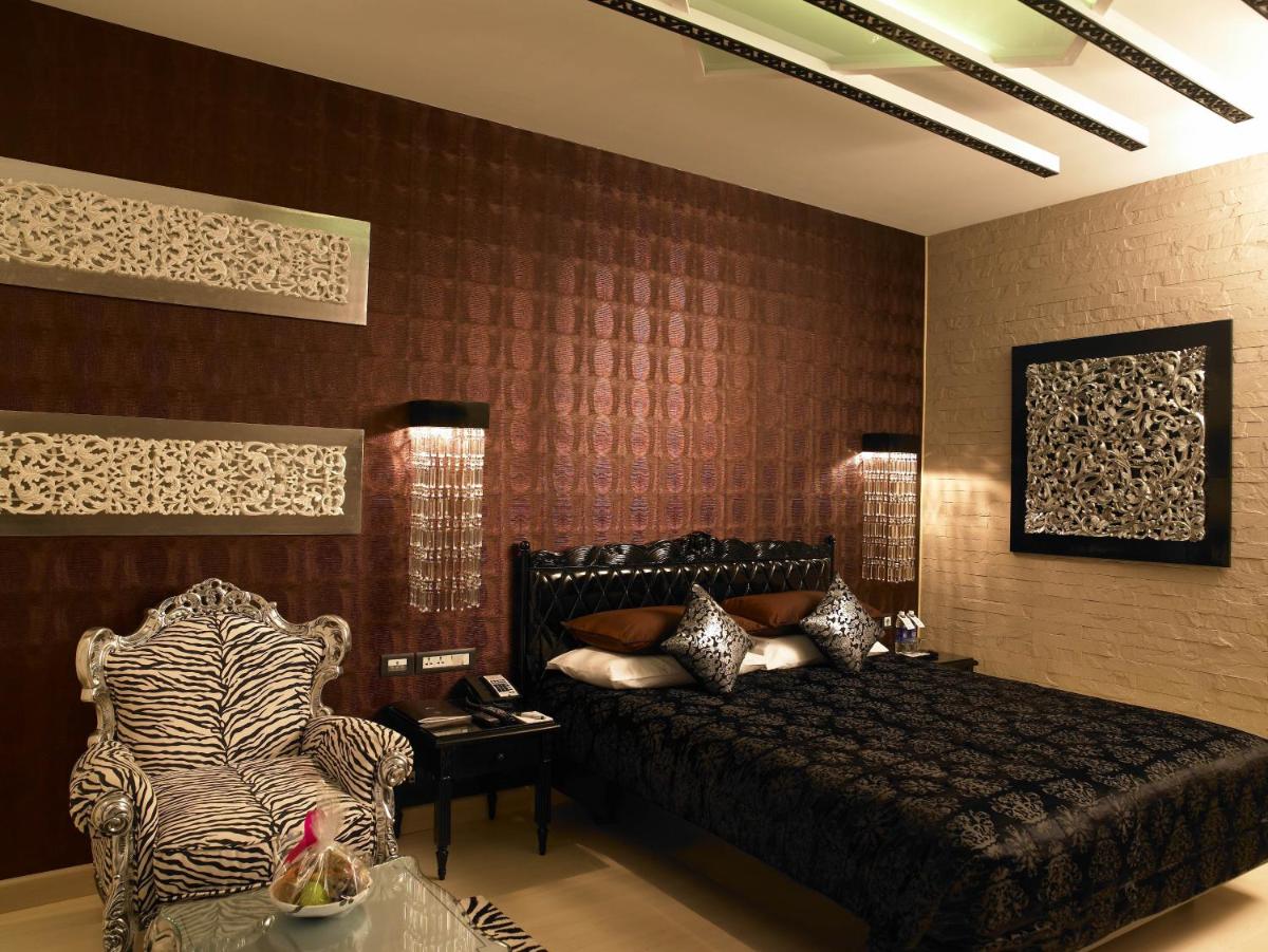 a bedroom with a bed and a zebra print wall at The Zuri Whitefield Bengaluru in Bengaluru