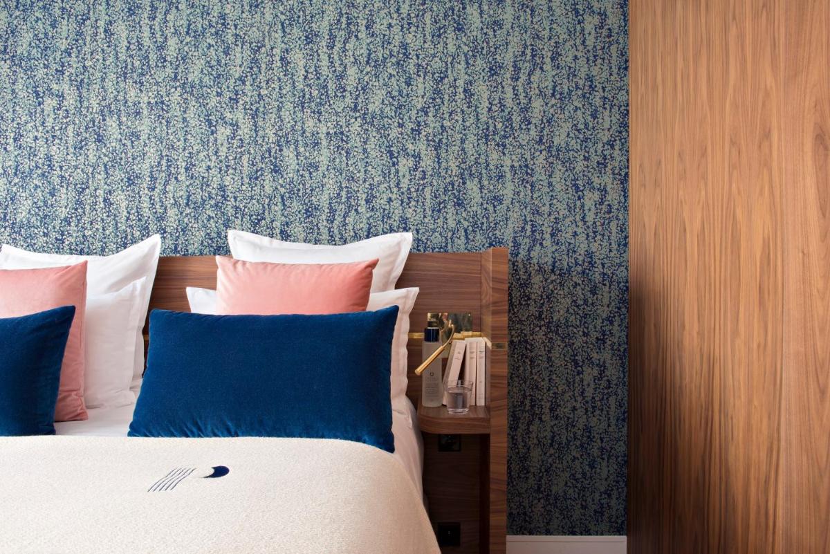 Un ou plusieurs lits dans un hébergement de l'établissement Hotel Parister Piscine & Spa