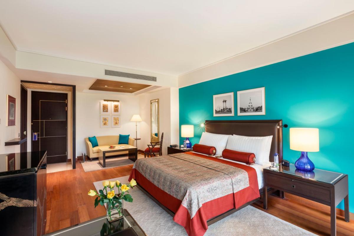 a bedroom with a bed and a blue wall at The Oberoi New Delhi in New Delhi a bedroom with a bed and a blue wall at The Oberoi New Delhi in New Delhi