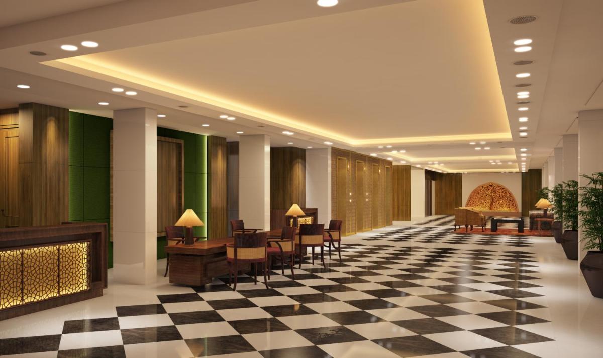 a lobby with a checkered floor and tables and chairs at The Oberoi New Delhi in New Delhi a lobby with a checkered floor and tables and chairs at The Oberoi New Delhi in New Delhi
