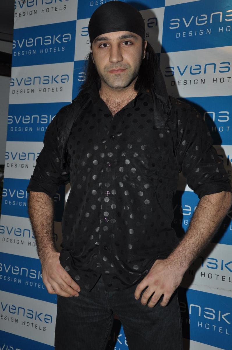 a man wearing a black shirt and a black hat at Svenska Design Hotel in Mumbai