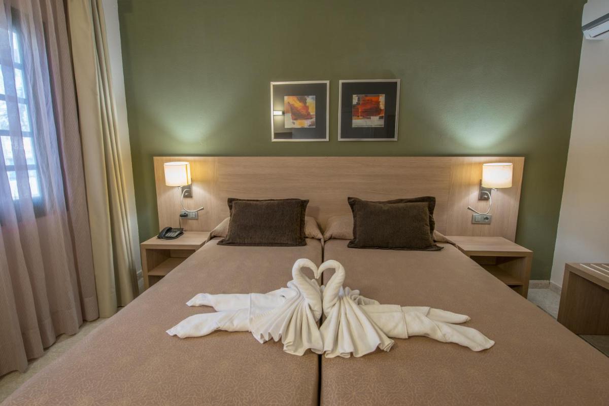 Cama o camas de una habitación en Relaxia Lanzasur Club - Aqualava Water Park