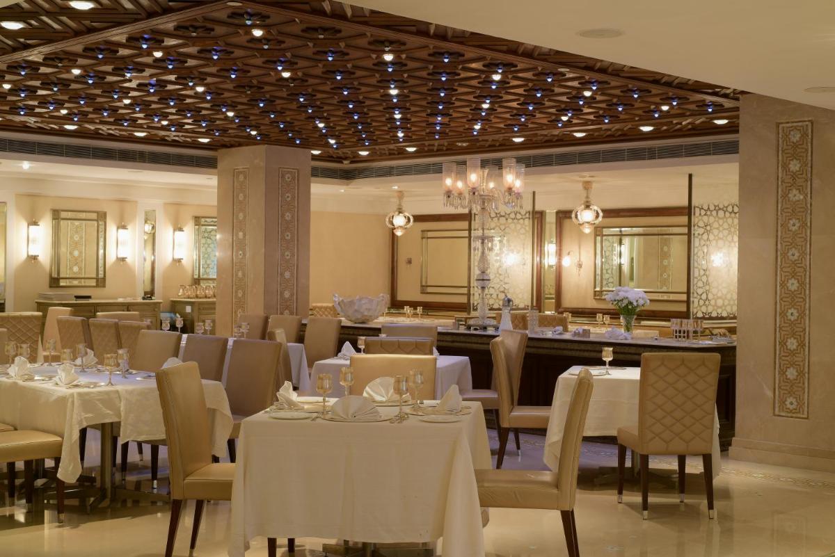 a restaurant with white tables and chairs and lights at The Park Hyderabad, Banjara Hills near Hussain Sagar Lake in Hyderabad a restaurant with white tables and chairs and lights at The Park Hyderabad, Banjara Hills near Hussain Sagar Lake in Hyderabad