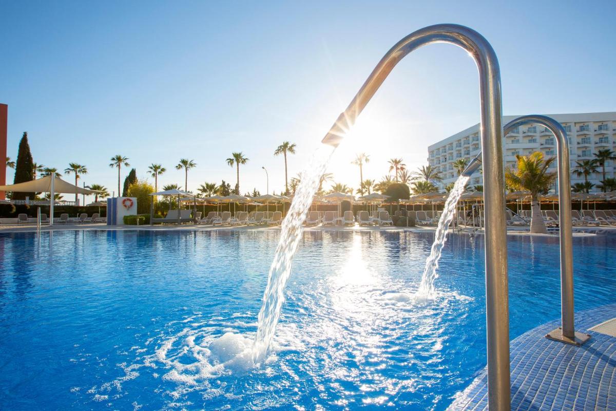 una fuente en una piscina en un complejo en Hipotels Cala Millor Park, en Cala Millor